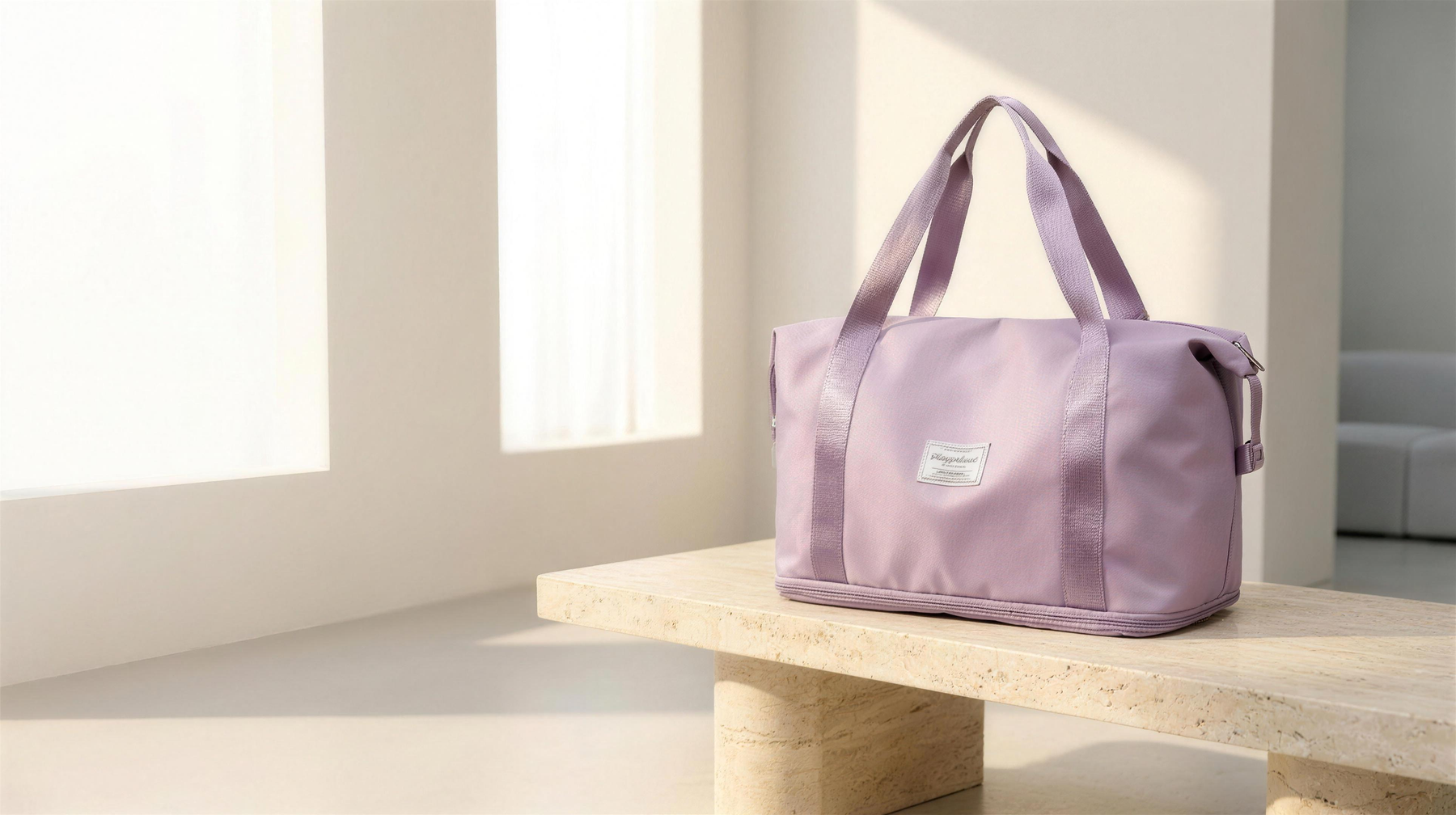 Zone Bag expandable gym duffel in lavender on a stone bench